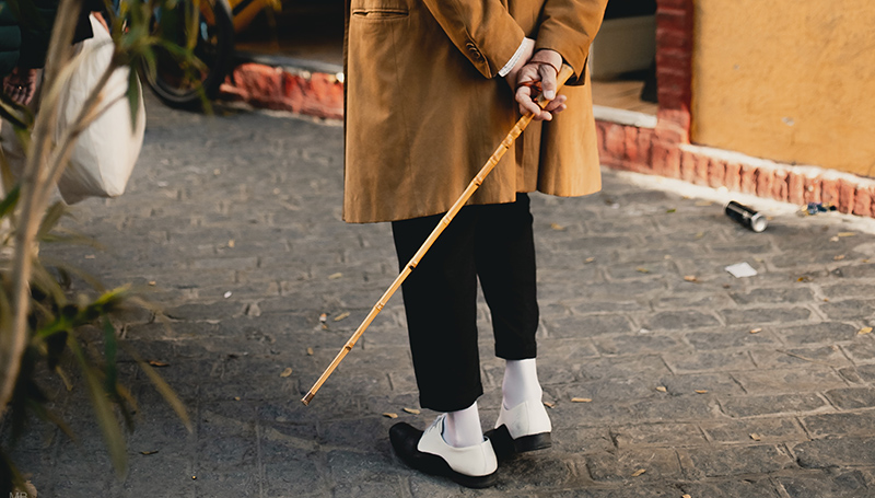 holding-wooden-walking-cane